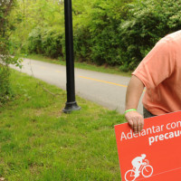 Bicycle Friendly Business Designation NWA Democrat-Gazette/ANDY SHUPE - Daniel Butterfield with Specialized Real Estate Group places signs along Scull Creek Trail Wednesday, April 22, 2015, in Fayetteville. The signs suggest riding etiquette for trail users and were provided for by a donation from Specialized Real Estate Group.
