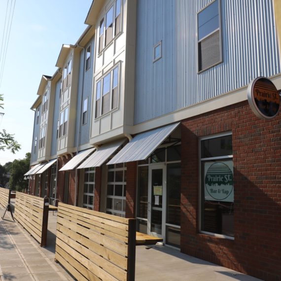 Three story building with Prairie Street Tap on first floor and apartments above