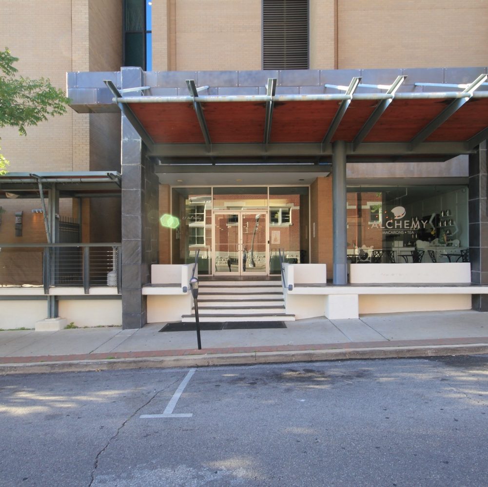 Pre-renovation brown brick entry to 112 W Center