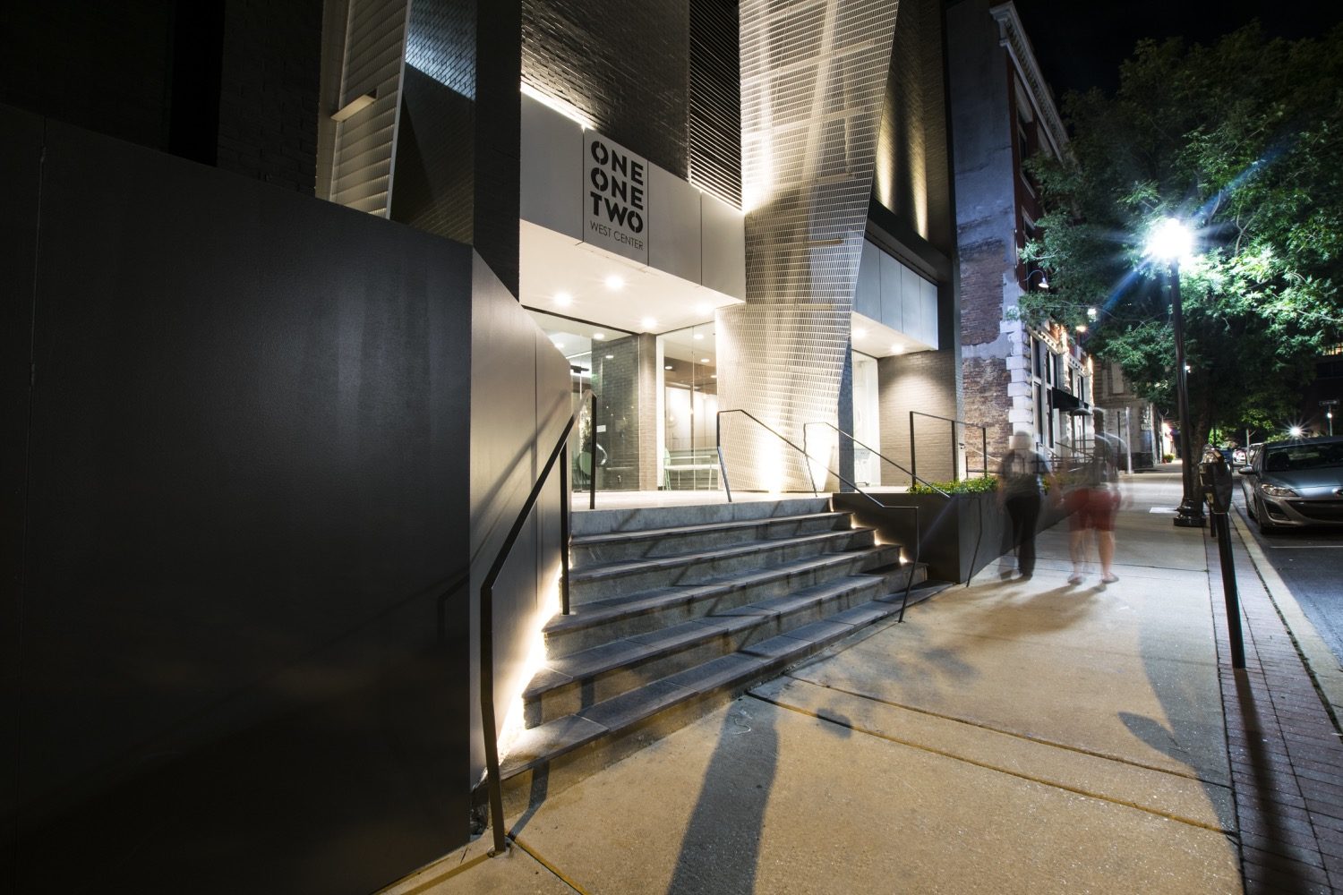 Night-view-of-sidewalk-and-front-entry-of-112-W-Center